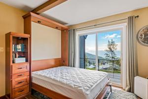 a bedroom with a bed and a large window at Crystal Run in Sandpoint
