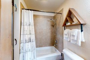 a bathroom with a shower and a white tub at Dover Hideaway in Dover +23 photos