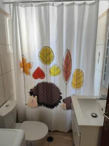 a bathroom with a shower curtain with a hedgehog on it at NaxosChoraNext in Galanádhon +14 photos