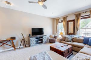 a living room with a couch and a tv at Heavenly Hideaway in Ludlow
