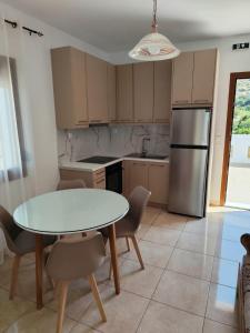 a kitchen with a table and chairs and a refrigerator at NaxosChoraNext in Galanádhon