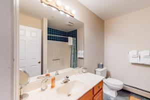 a bathroom with a sink and a toilet and a mirror at Heavenly Hideaway in Ludlow +26 photos