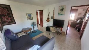 a living room with a couch and a television at Shaked בית שקד in Moshav Ramot