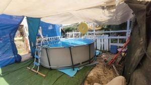 a large hot tub in a tent with at Shaked בית שקד in Moshav Ramot