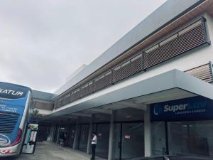 a man standing in front of a superlawix building at Prime Pousada - Posto Sudoeste Queimadas in Queimadas