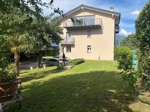 a large house with a yard in front of it at Patty House in Colico