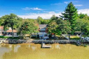 a large house with a dock in the water at 4 Bed 2 Bath Vacation home in Ossipee in Ossipee