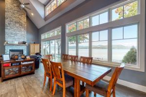 a dining room with a table and chairs and windows at 4 Bed 2 Bath Vacation home in Ossipee in Ossipee