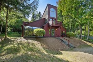 a home with a red house in the woods at Cow Hill Haven in Bartlett