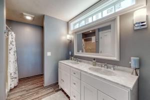 a bathroom with two sinks and a large mirror at 4 Bed 2 Bath Vacation home in Ossipee in Ossipee +70 photos