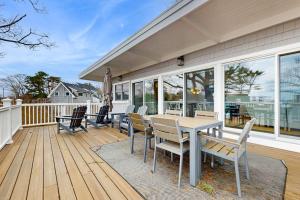 a patio with a table and chairs on a deck at Wallis Sands Beach Serenity in Rye