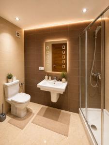 a bathroom with a toilet and a sink and a shower at Residence vigier in Tangier