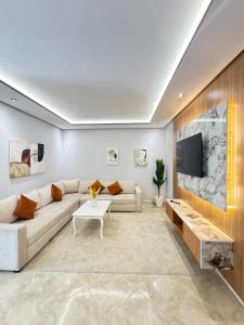 a living room with a couch and a tv at Residence vigier in Tangier