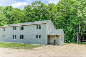 a gray house with a garage in front of trees at Bear Village 14 in Bartlett