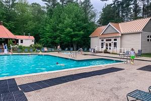 a swimming pool with people playing in the water at Bear Village 14 in Bartlett
