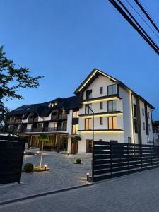 a large white building with a fence in front of it at Edelweiss New 2026 Солотвино in Solotvyno