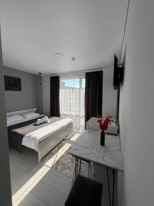 a bedroom with two beds and a table and a window at Edelweiss New 2026 Солотвино in Solotvyno +11 photos