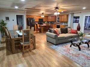 a living room with a couch and a table at Lakefront withTreehouse & Pool, Hottub, Gameroom in Azle