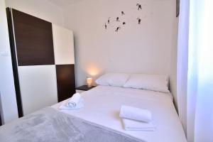 a bedroom with a bed with two towels on it at Villa Natali in Pridraga +71 photos