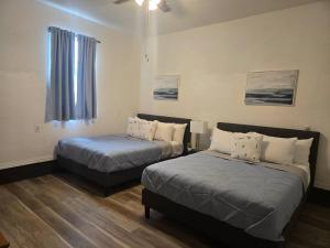 a room with two beds and a window at Lakefront withTreehouse & Pool, Hottub, Gameroom in Azle +28 photos