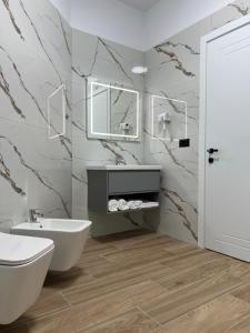 a bathroom with a sink and a toilet and a mirror at Skanderbeg Hotel in Krujë +71 photos