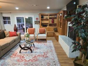 a living room with a couch and a fireplace at Lakefront withTreehouse & Pool, Hottub, Gameroom in Azle