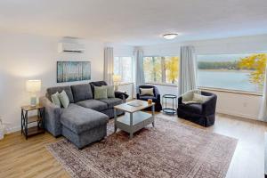 a living room with a couch and two chairs at The River House in Sandpoint