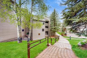 a house with a fence next to a walkway at Valley Gem Lower in Sun Valley