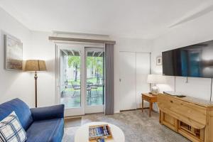 a living room with a blue couch and a tv at Valley Gem Lower in Sun Valley