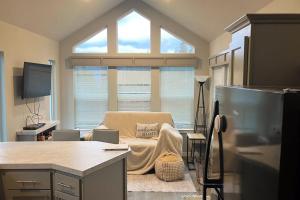 a living room with a couch and a window at Tiny Lake Retreat in Sagle