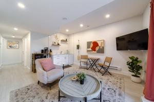 a living room with a couch and a table at Chic Hideaway - King Bed - Fireplace - Garage - AC - DT and WEM in Edmonton