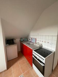 a small kitchen with a stove and a sink at Gasthaus Liam 4 in Bendorf