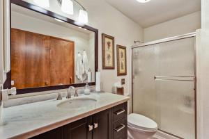 a bathroom with a sink and a toilet and a shower at Sandpoint Paradise in Sandpoint +55 photos