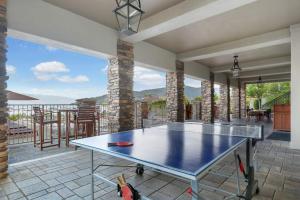 a ping pong table on a patio with a view at Seasons 331 - Penthouse in Sandpoint