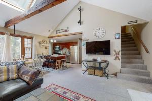 a living room with a couch and a table at Whispering Brook Townhouse in Bartlett