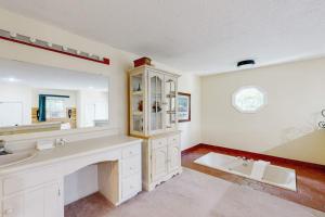 a bathroom with a sink and a large mirror at Whispering Brook Townhouse in Bartlett +43 photos