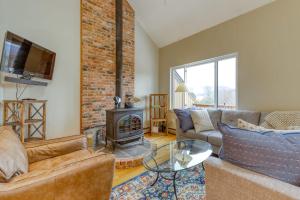 a living room with a couch and a fireplace at Attitash Woods Escape in Bartlett