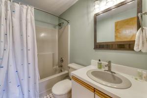 a bathroom with a sink and a shower curtain at Attitash Woods Escape in Bartlett +36 photos