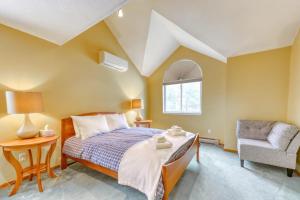a bedroom with a bed and a chair and a window at Attitash Woods Escape in Bartlett