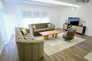 a living room with a couch and a table at Villa Dubrava in Matuzići +13 photos