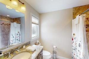 a bathroom with a sink and a toilet and a mirror at 61 East Field Road in Jackson +43 photos