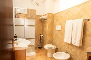a bathroom with a toilet and a sink at Macri Alghero in Alghero