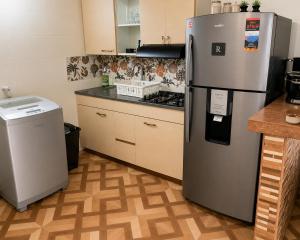 a kitchen with a stainless steel refrigerator and a stove at Aparta Suites Torre de Prado 502 Apartamento para 5 Personas in Medellín