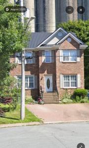 a brick house with a pole in front of it at COZY-Inn in Halifax