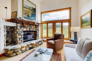 a living room with a large stone fireplace at Legends Hideout in Sun Valley