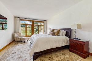 a bedroom with a bed and a dresser and a window at Legends Hideout in Sun Valley +59 photos