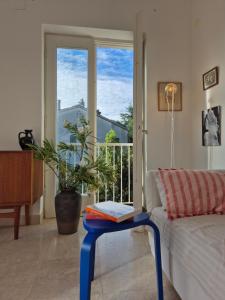 a living room with a couch and a table with a book on it at Otto Novalja, spacious penthouse apartment in city center in Novalja