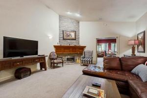 a living room with a couch and a flat screen tv at Riverside Bliss in Bellevue
