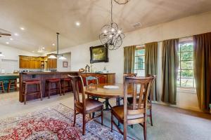 a dining room and kitchen with a table and chairs at Riverside Bliss in Bellevue