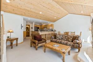 a living room with a couch and a table at Schweitzer Ullr Retreat in Sandpoint